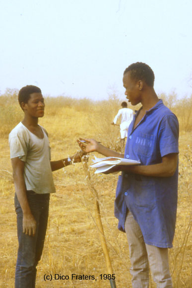 photo of two men greeting each other in a field