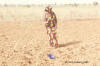 Work, photo of a woman sowing millet