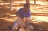 Man: photo of a man repairing a saddle