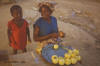 Orange: photo of woman selling peeled oranges.