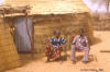 Chair: photo of man and wife sitting on chairs in front of their house