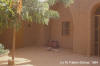 clay water pot: photo of two earthenware jars next to loam house.